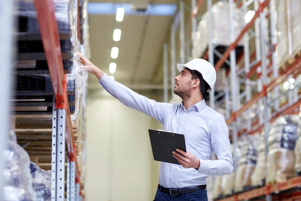 Manager checking items at the warehouse