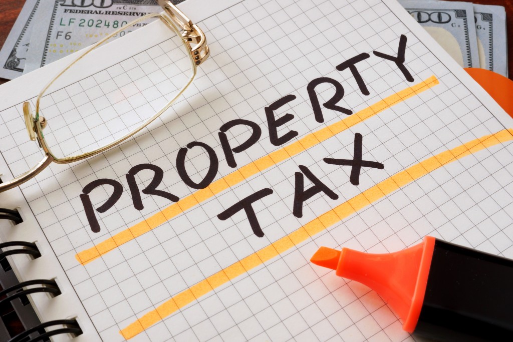 Notebook with property tax sign on a table. Business concept.