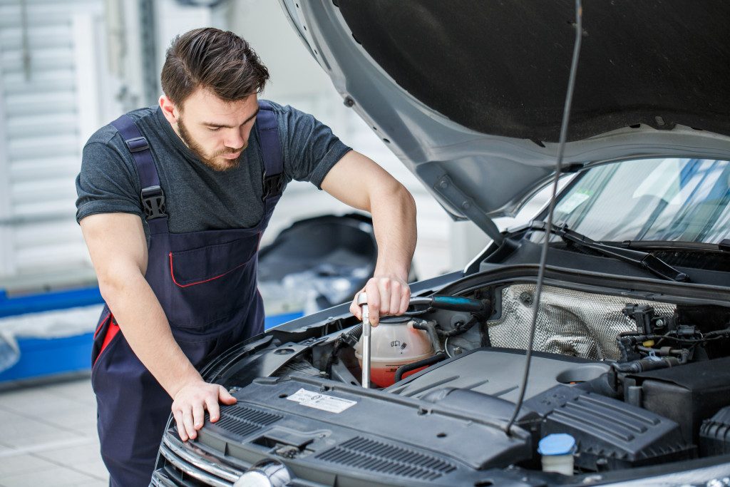 Man checking car engine