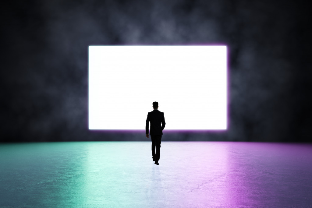 A man walking into an LED wall in dark background
