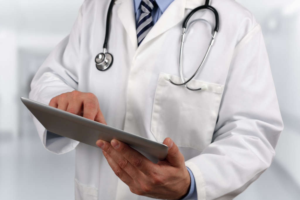 a doctor using digital tablet